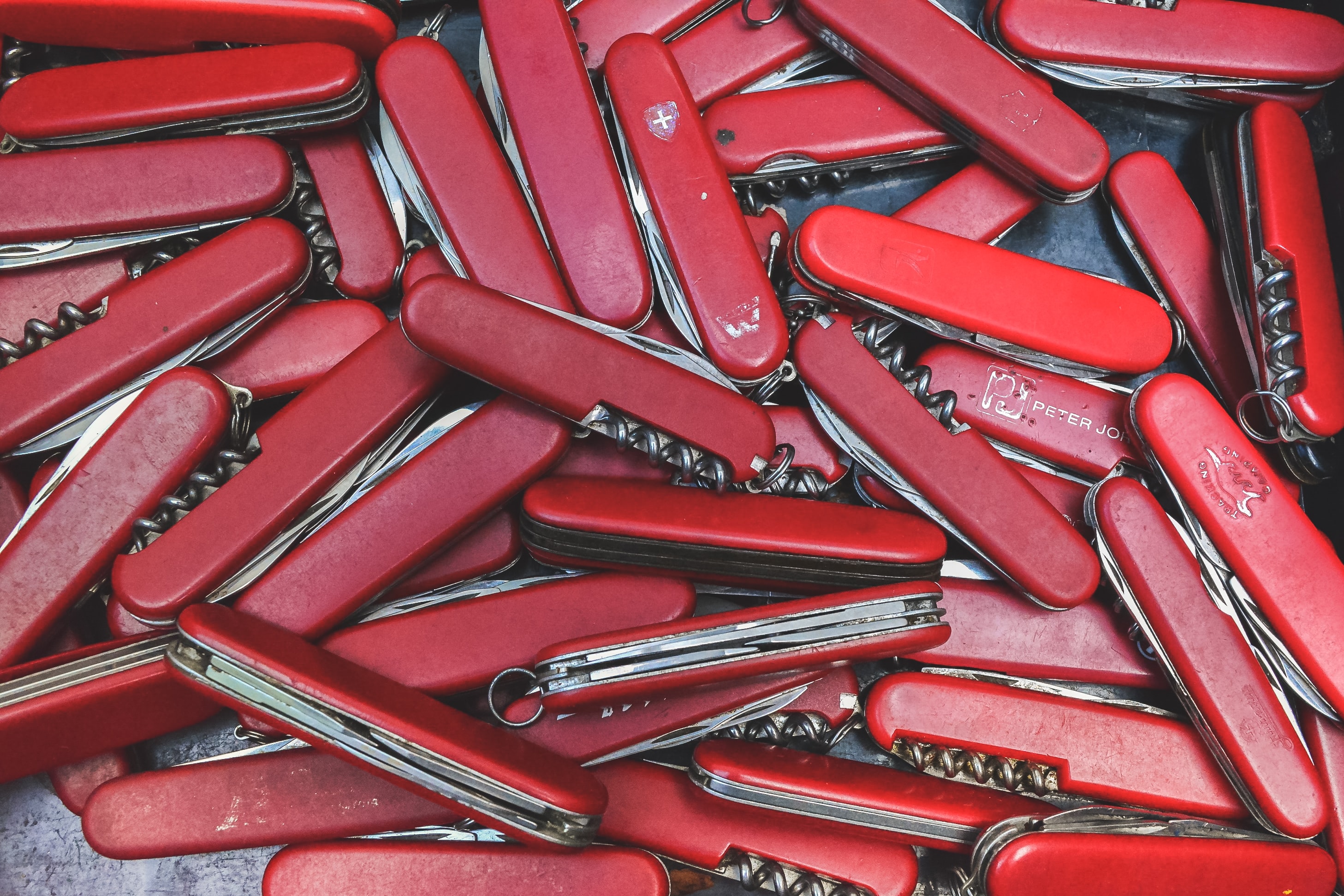 Closeup of many Swiss Army knives